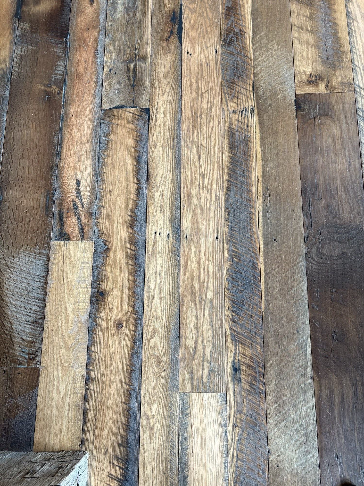 Finished reclaimed-wood plank flooring detail completed by our crew